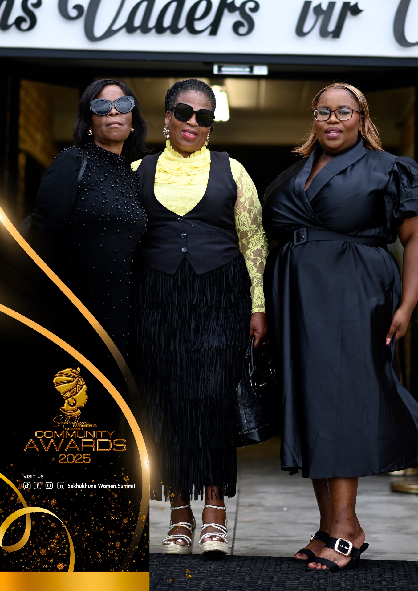 Three guests posing at the entrance